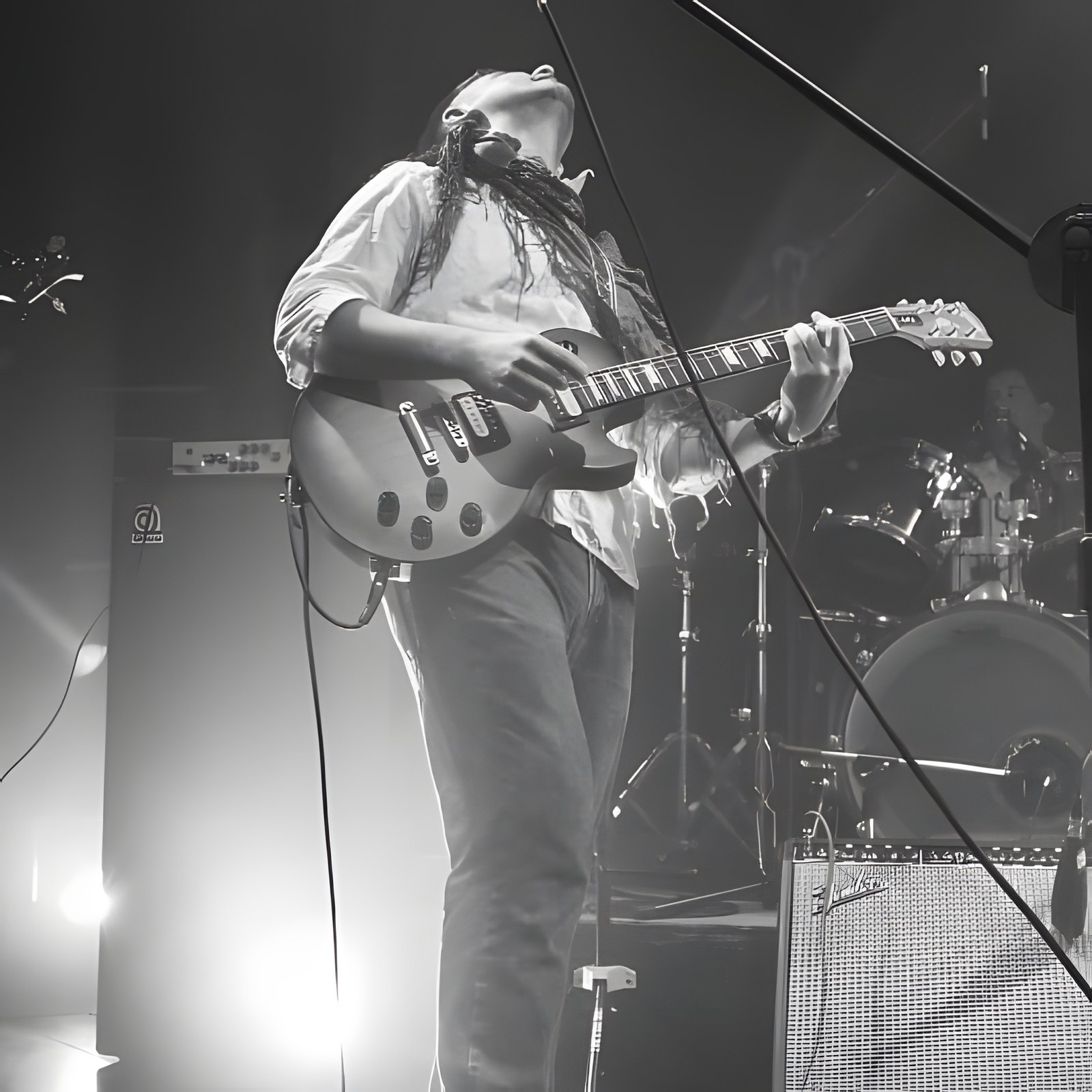 Black and white photo of guitarist mid-solo