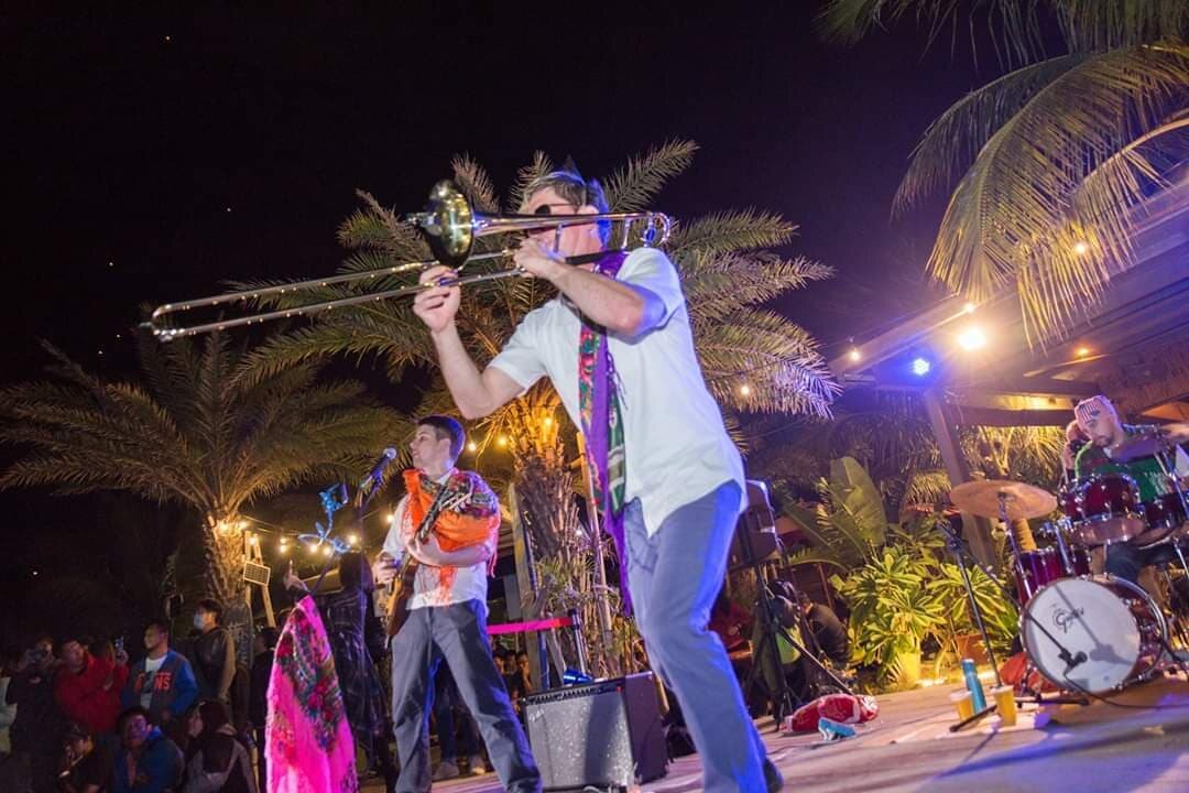 Balkazar's trombonist performing with the crowd behind him