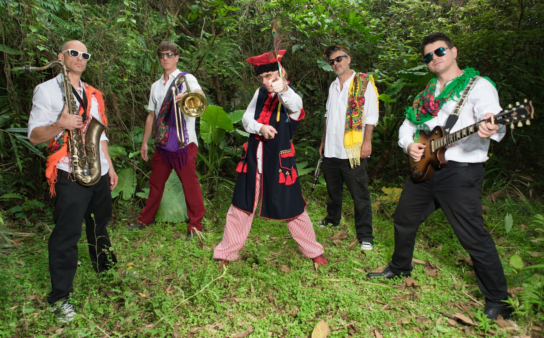 Balkazar posing with their instruments in the forest at Veggie Fest